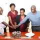 Left to Right: Dr. Justus Twesigye, Dean of the School of Social Sciences cuts cake with Retirees: Ms. Doreen Anek, Ms. Kitty Tweyanze and Mr. Jackson Byamugisha. School of Social Sciences, College of Humanities and Social Sciences (CHUSS), Tororo Girls School, Kampala Uganda, East Africa, farewell ceremony to honor three retired staff members for their exemplary service. Retirees Ms. Doreen Anek, the Senior Assistant Registrar; Ms. Kitty Tweyanze, Senior Administrative Secretary; and Mr. Jackson Byamugisha, a Security guard, 2nd September 2024.